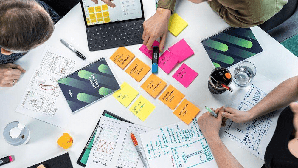 A team mapping ideas on sticky notes around a table